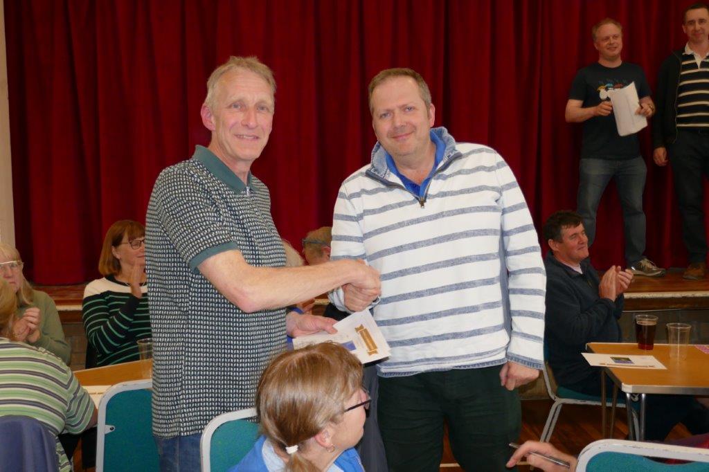 Simon Linford handing the winning certificate to Michael Wilby